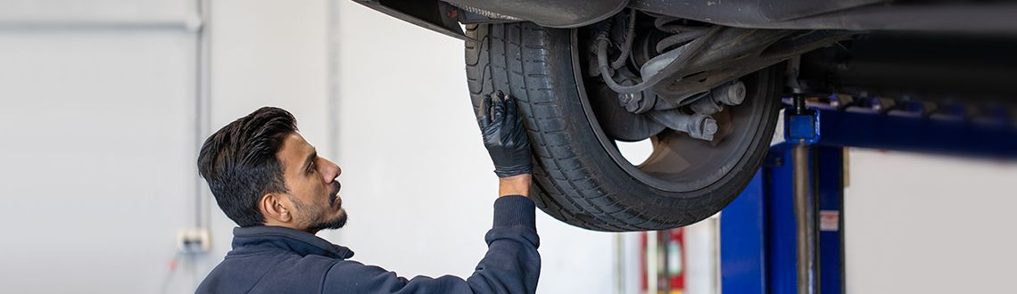 Mechanic checking tyre pressure