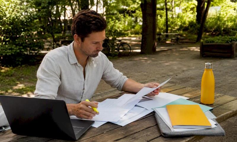 Man reviewing German health insurance documents at home