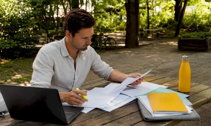 Man reviewing German health insurance documents at home