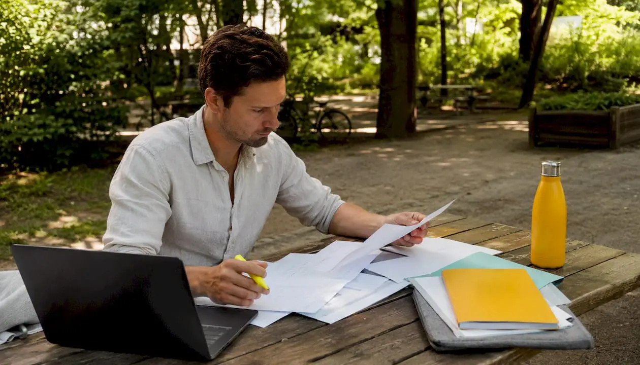 Man reviewing German health insurance documents at home