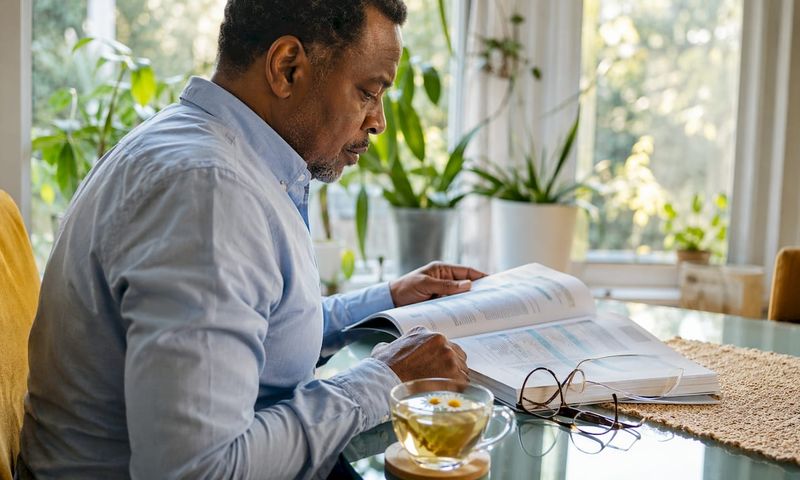 Man reviewing care insurance paperwork at home