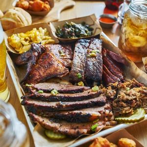 texas style bbq tray with smoked brisket, st louis ribs, pulled pork, chicken, hot links, and sides