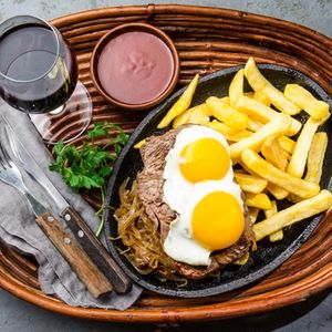 Peruvian Latin American food. Lomo a lo pobre. Beef tenderloin whit fried potatoes french fries and eggs