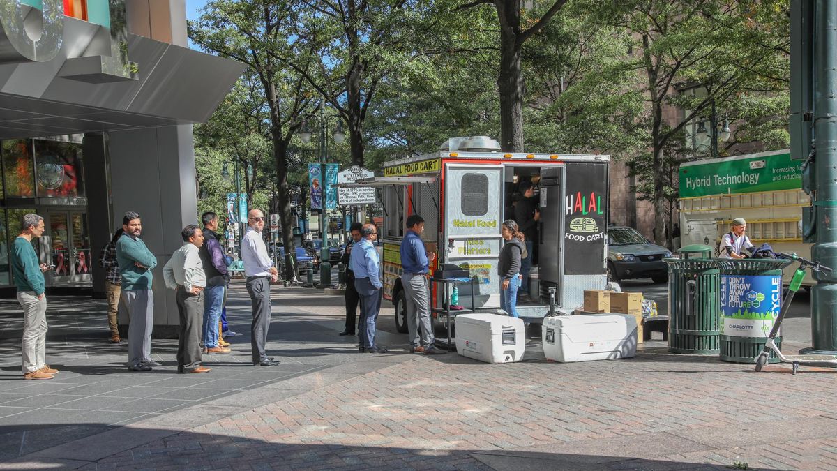 CHARLOTTE, NC, USA-10/30/18: Customers waiting in line at a food cart on Tryon St.