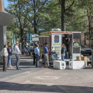 CHARLOTTE, NC, USA-10/30/18:  Customers waiting in line at a food cart on Tryon St.