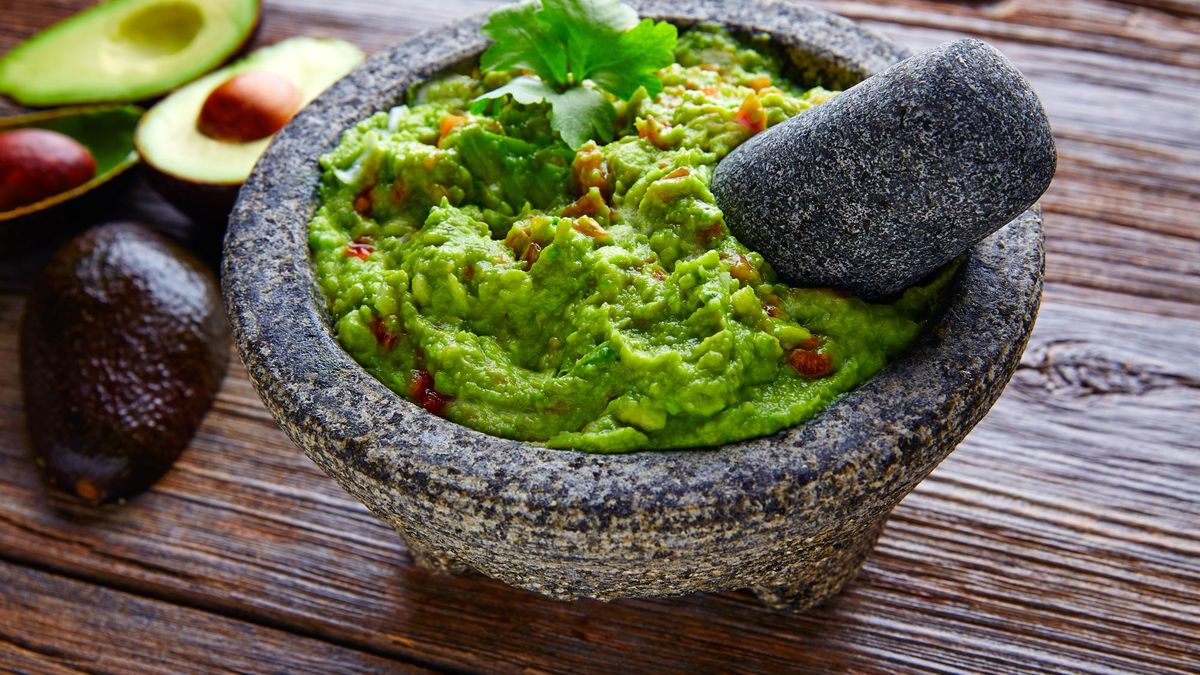 avocado Guacamole on molcajete real Mexican traditional procedure