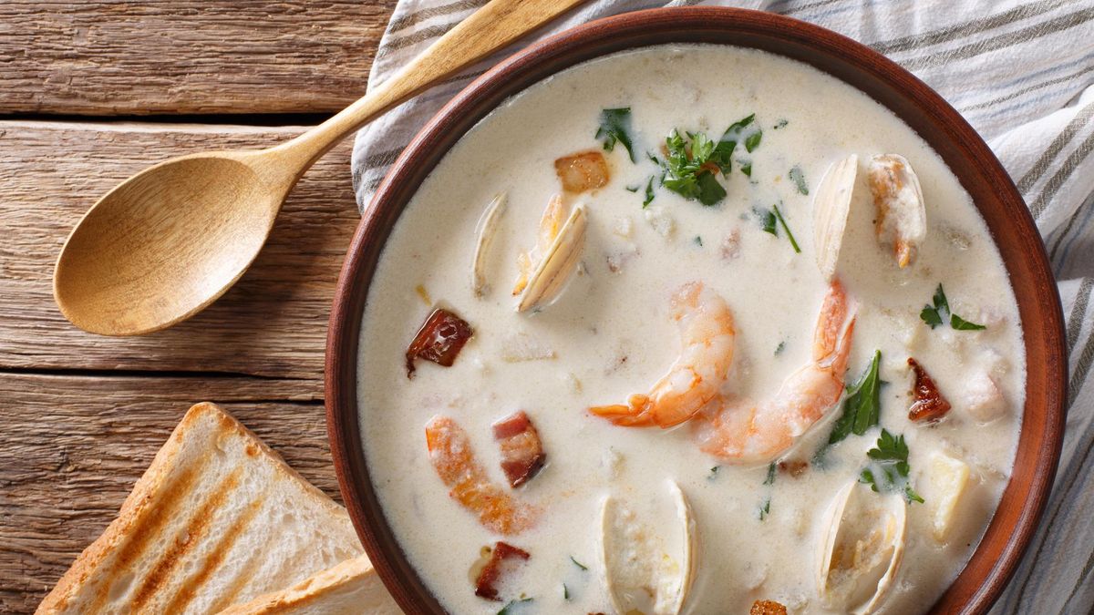 American food: New England clam chowder soup close-up on a in a bowl on the table. horizontal view from above