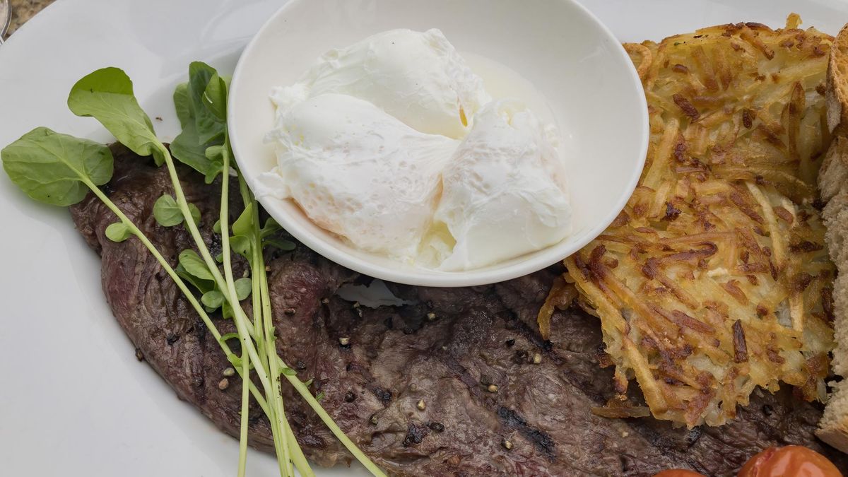 Close up shot of a plate of fried steak, poached eggs and hash brown, ate at Sedona, Arizona
