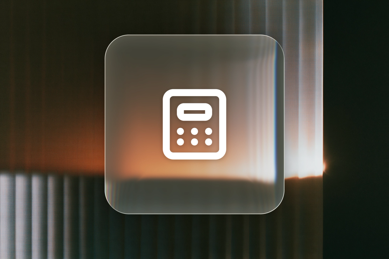 A white calculator icon on a frosted-glass tile against amber-lit fluted glass.