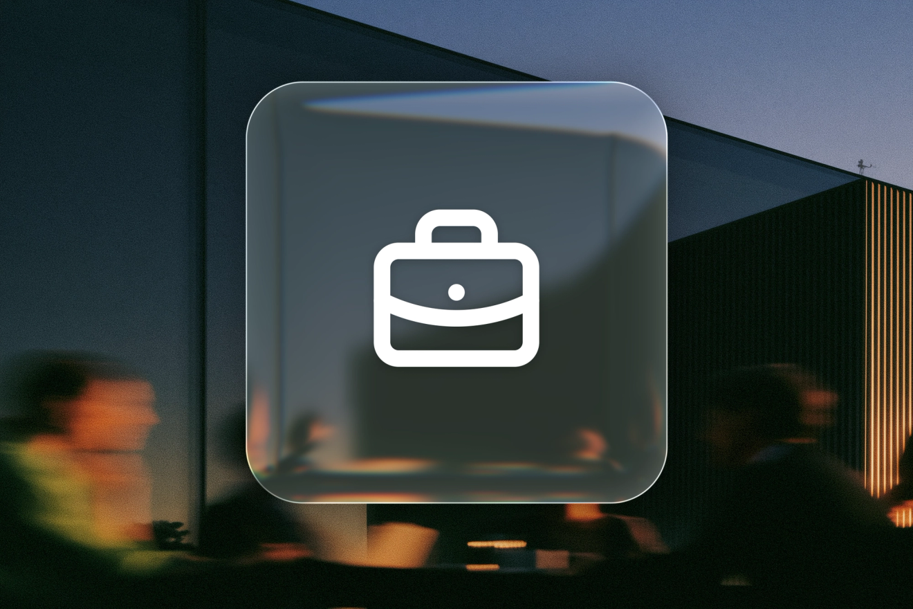 A white briefcase icon on a frosted-glass tile over a blurred workplace scene.