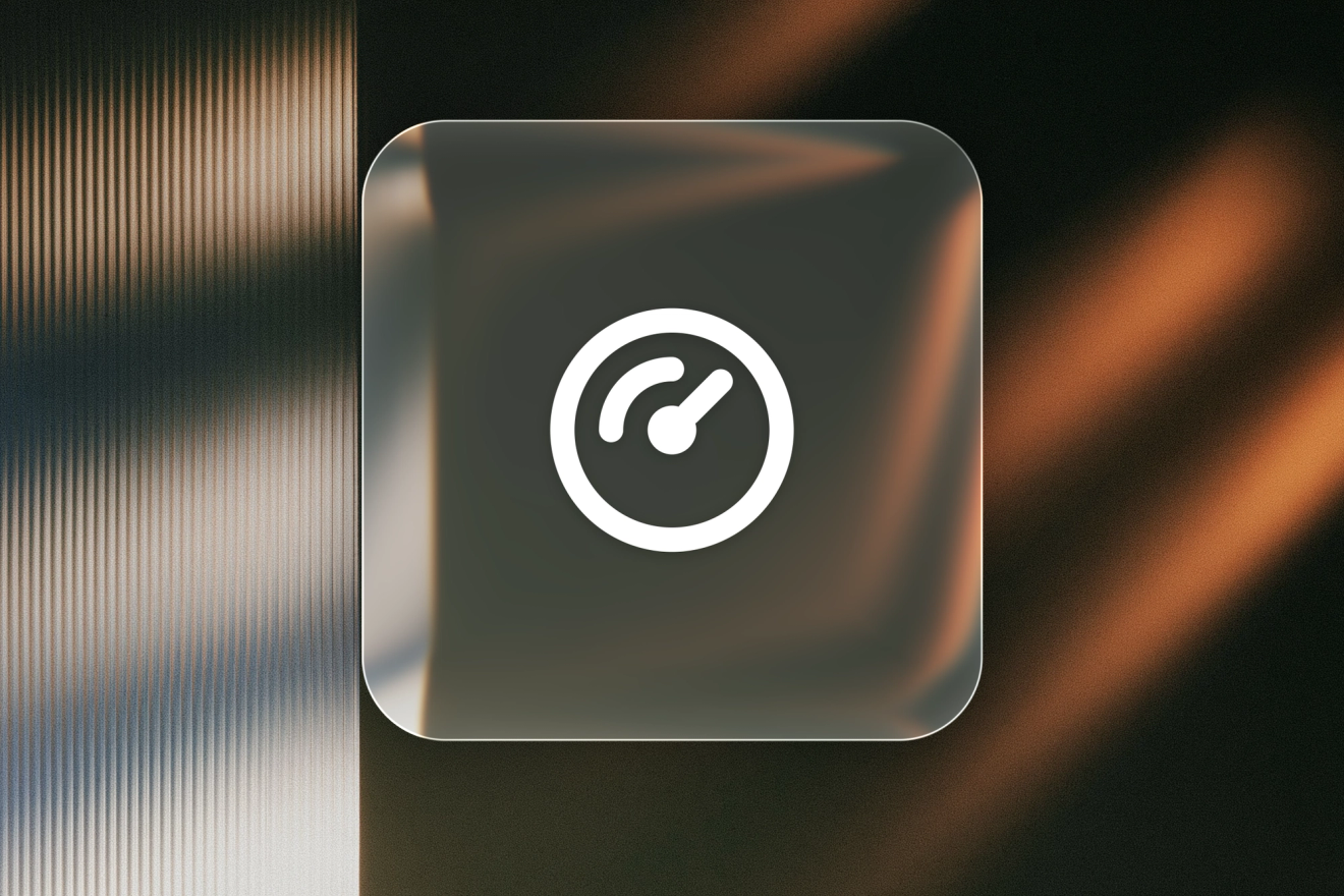Speedometer gauge icon on a frosted glass tile against a dark background with warm orange light