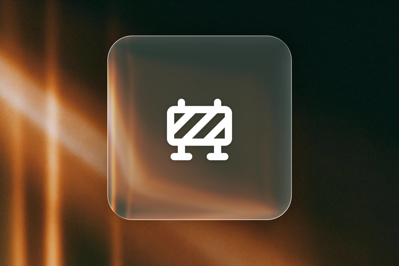 A white safety-barrier icon on a frosted-glass tile against amber light leaks