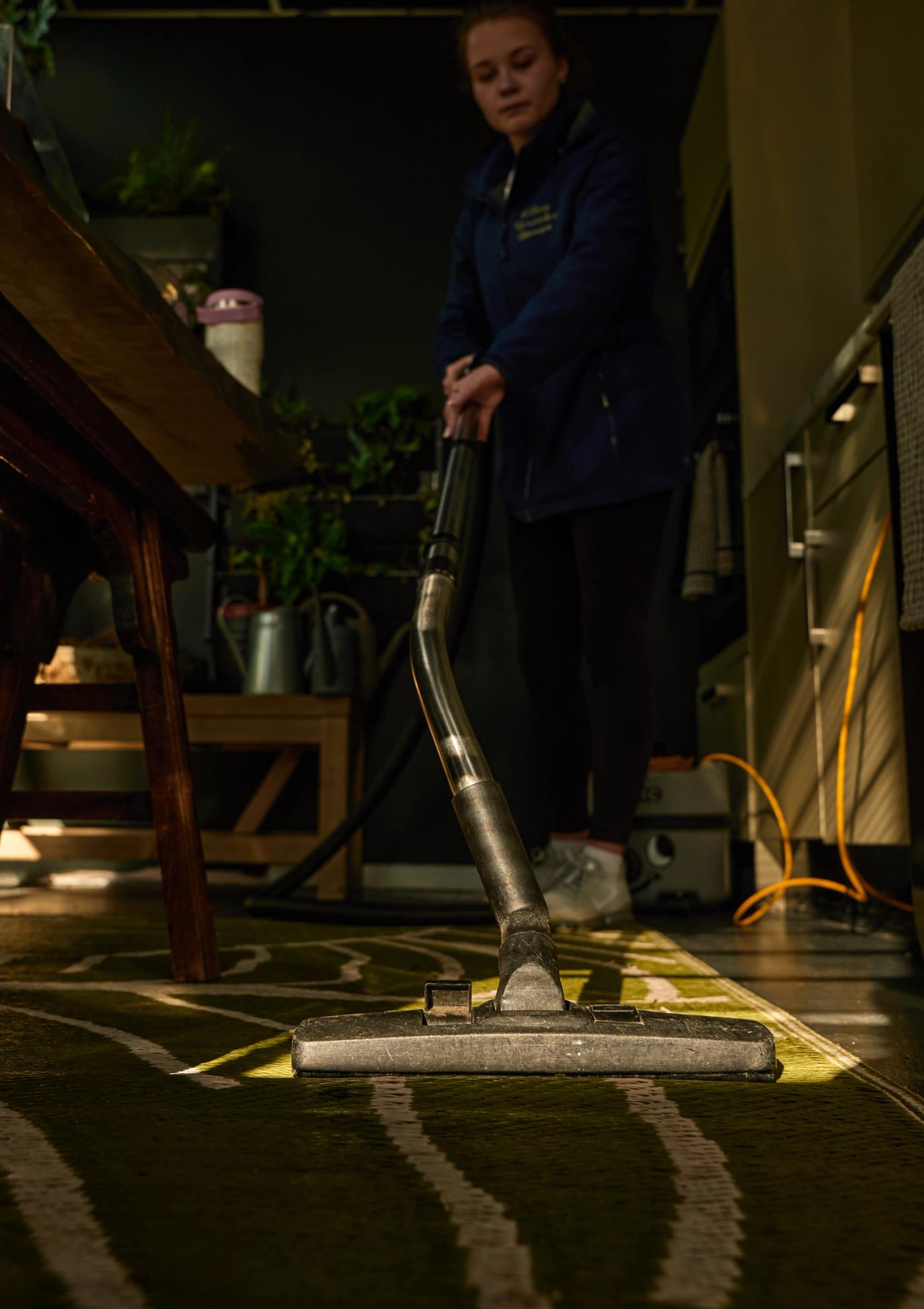 A newly renovated kitchen before an after builders clean, with fine dust on worktops, protective film on fittings, clean-lined cabinetry and renovation residue on the floor