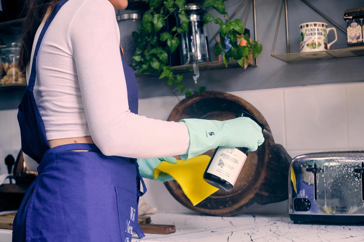 A professional cleaning team working through a newly refurbished sitting room, dusting high ledges, vacuuming edges and wiping skirting boards in a careful sequence