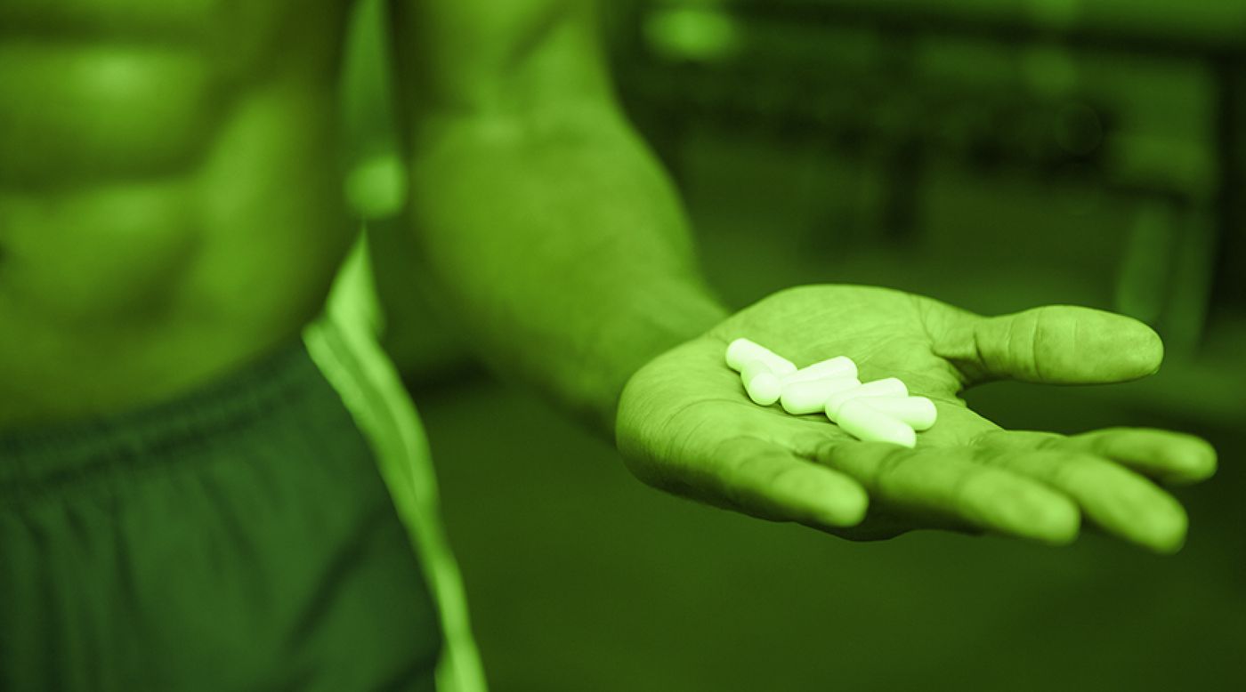 Drug free sport, athlete holding pills
