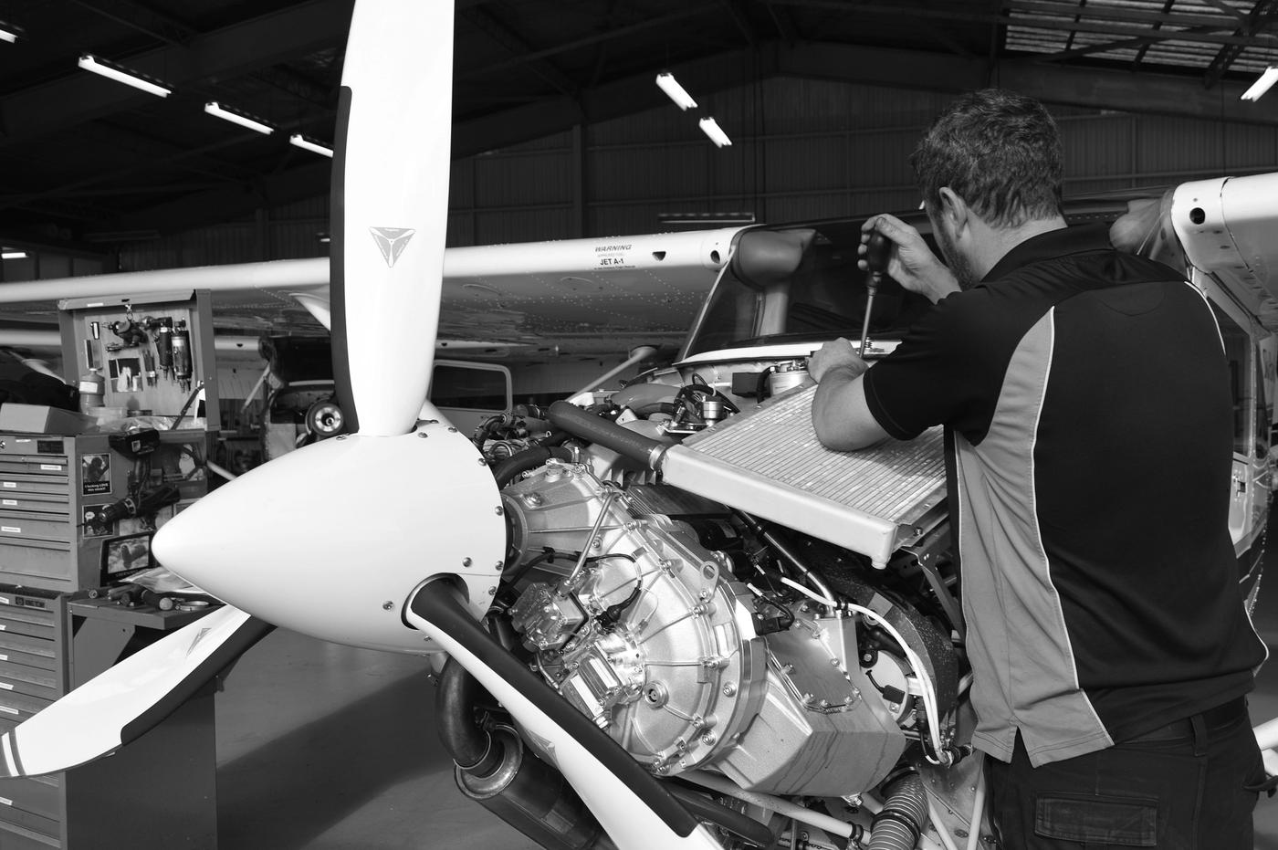 Man fixing plane engine