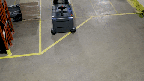 OTTO Lifter, an autonomous forklift, turning a corner to deliver a pallet.