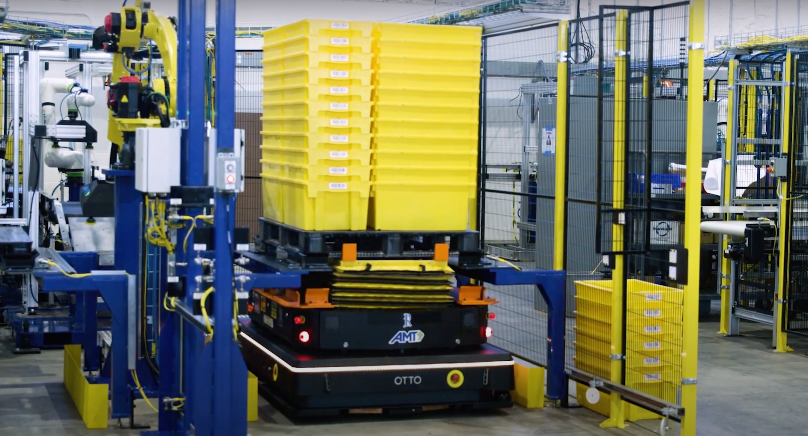OTTO 1500 autonomous mobile robot with lift attachment moving yellow buckets to P&D stand.