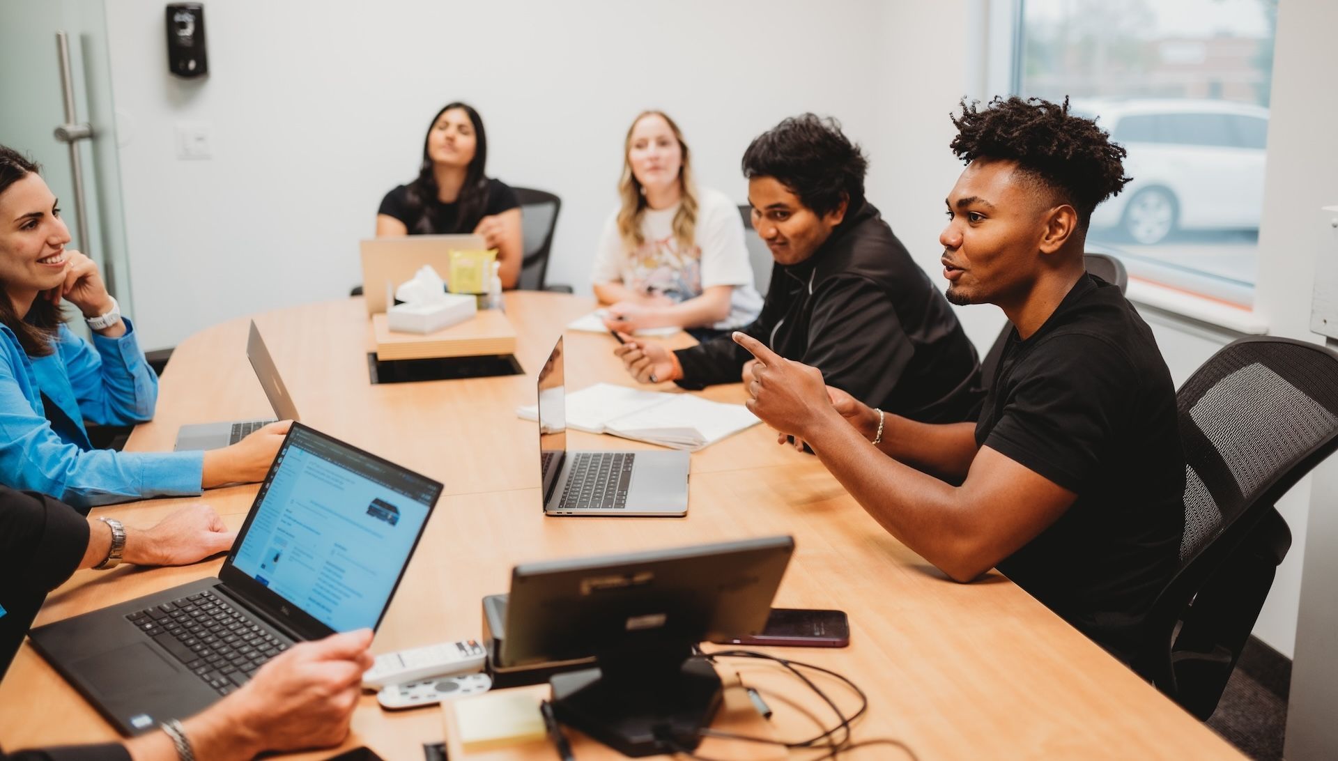 OTTO team members around an office table in training