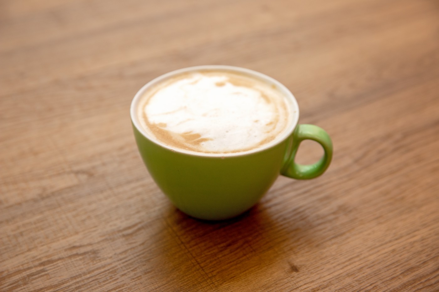 Latte art in a green cup