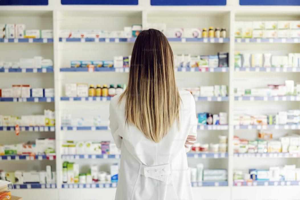 Pharma distribution manager reviewing inventory levels of antibiotics and pediatric medicine bottles before the monsoon season in India