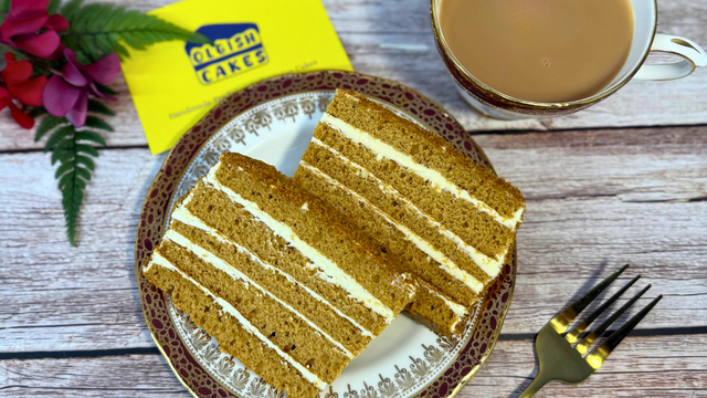 Postal cake box wrapped for UK delivery with neatly packed slices inside