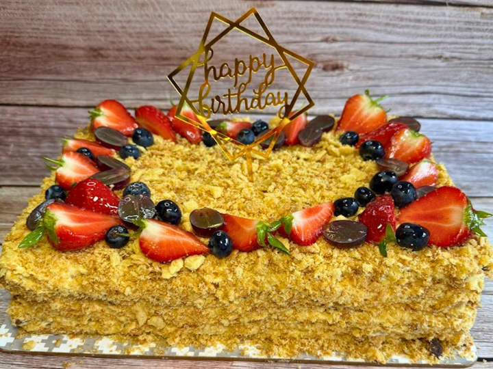 Close crop of Napoleon cake layers and cream on a serving plate