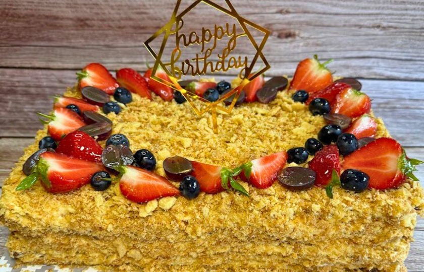 Close crop of Napoleon cake layers and cream on a serving plate