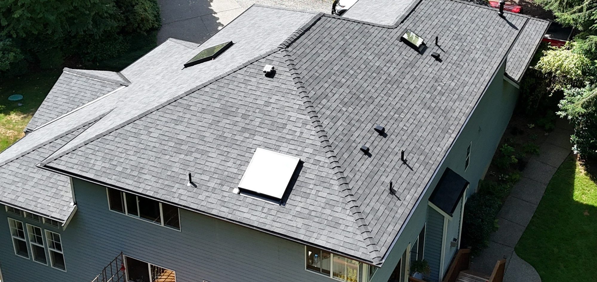 Drone view of the finished Malarkey Legacy Midnight Black asphalt shingle roof with new skylights, Lake Stevens, WA, by Amor Roofing