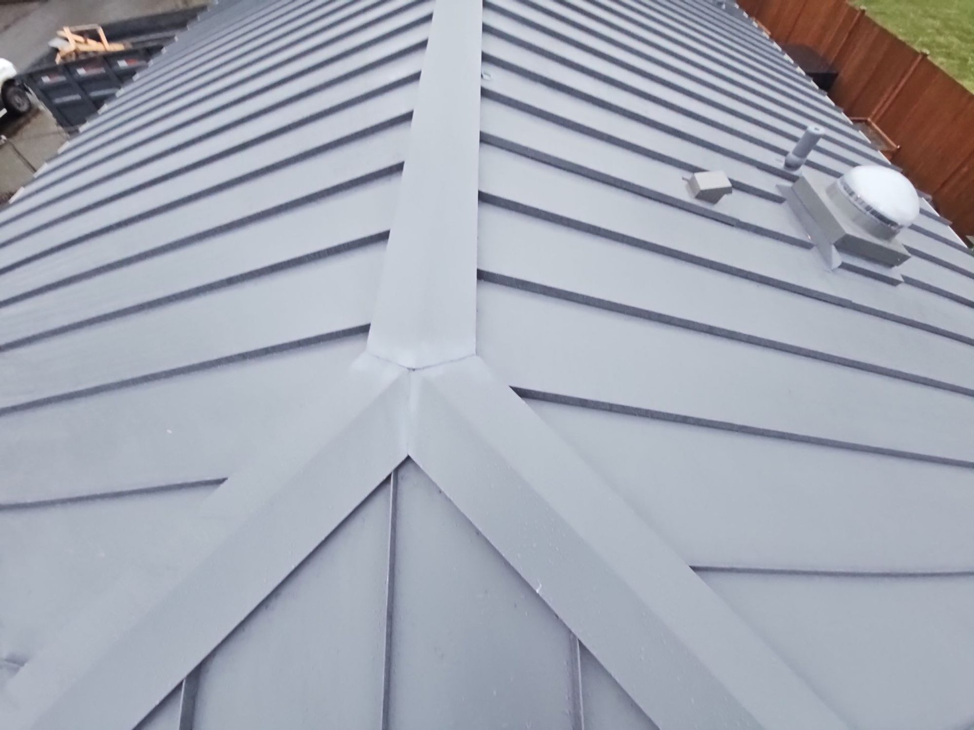 Pipe vent flashing and hip seams on the Cascade Gray standing seam metal roof, Woodinville, WA