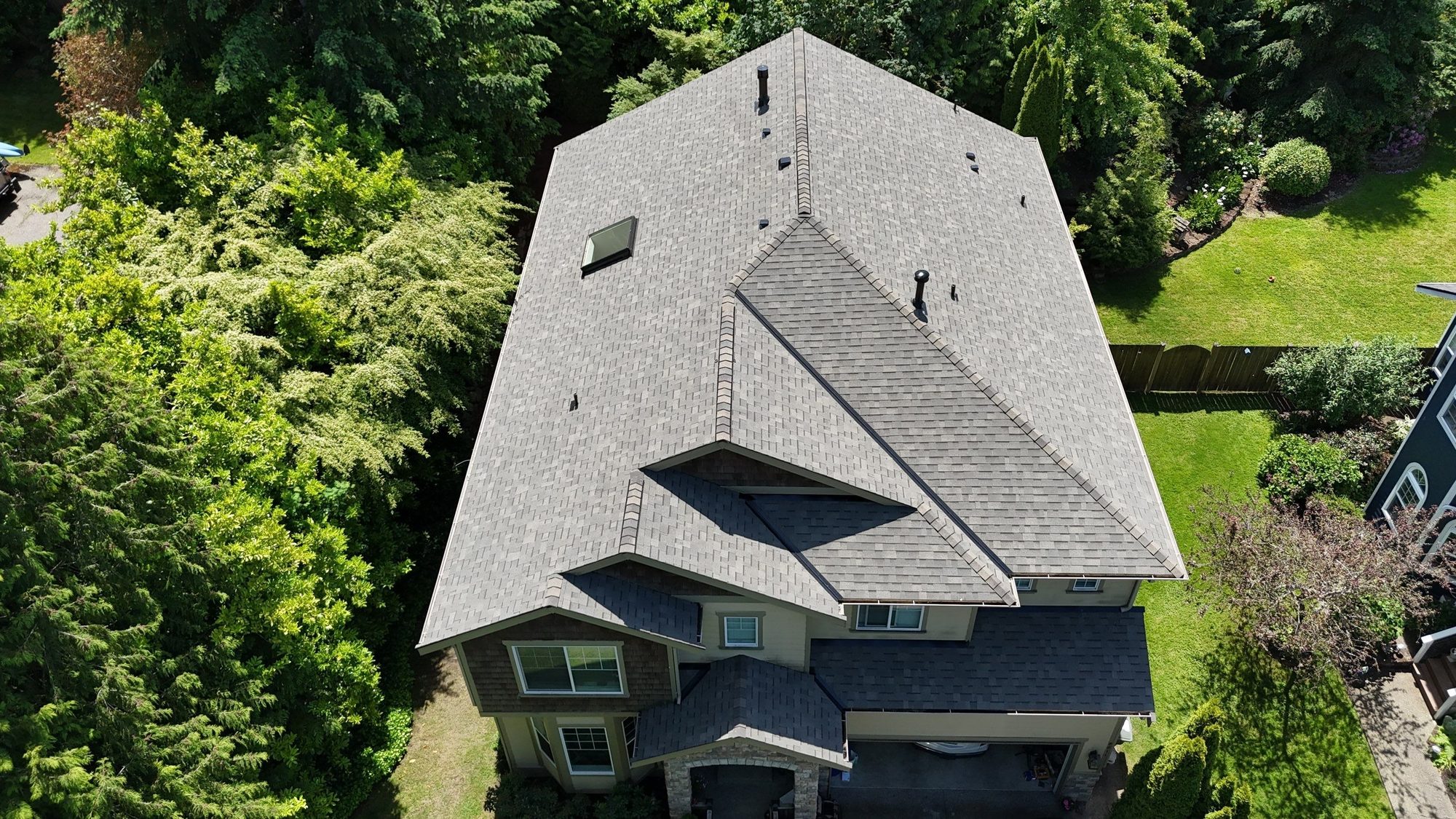 Amor Roofing Weathered Wood asphalt roof in Kenmore, drone rear dormers