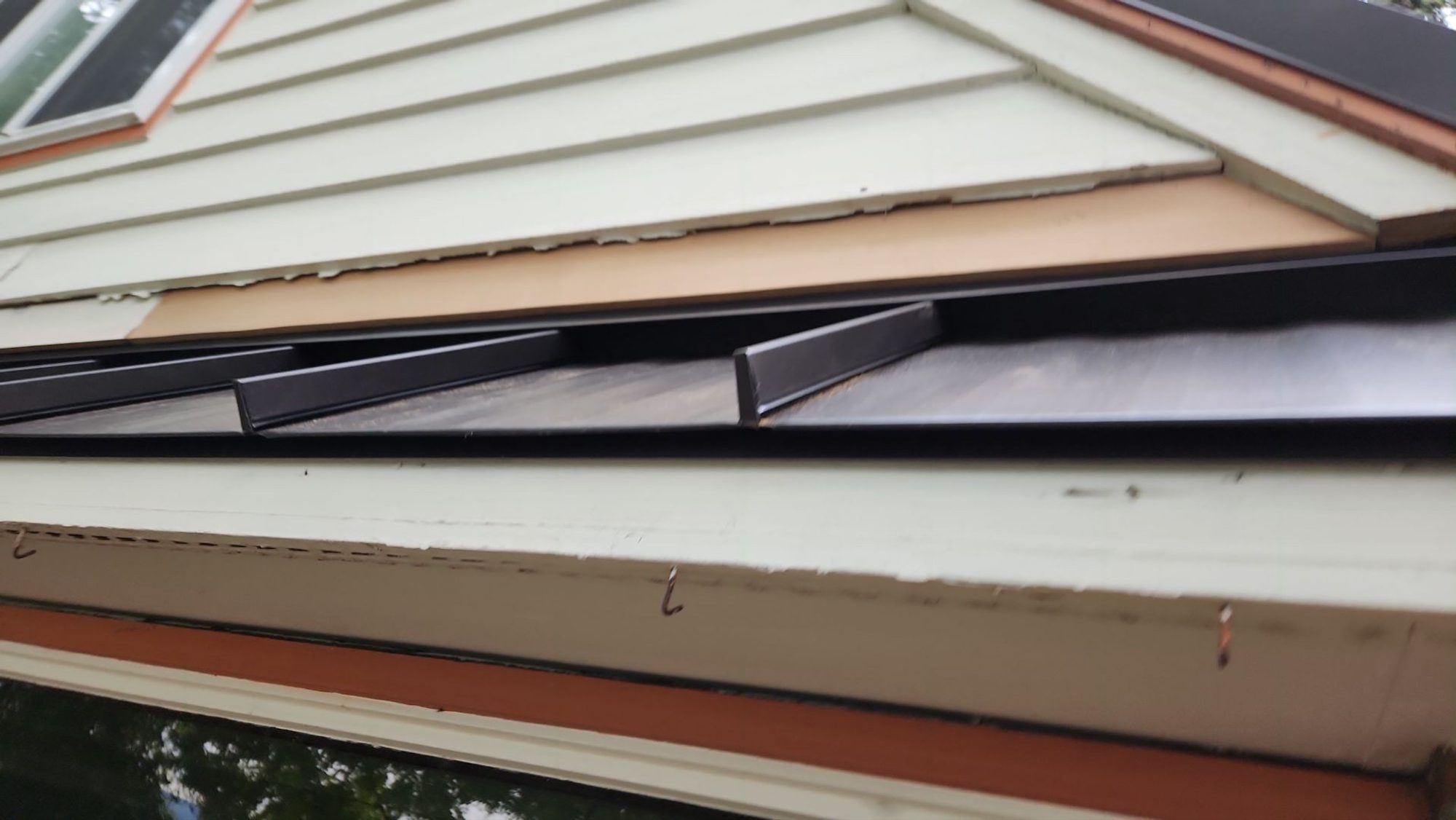 Ridge of the Dark Bronze standing seam metal roof looking down the panel run, Bellevue, WA