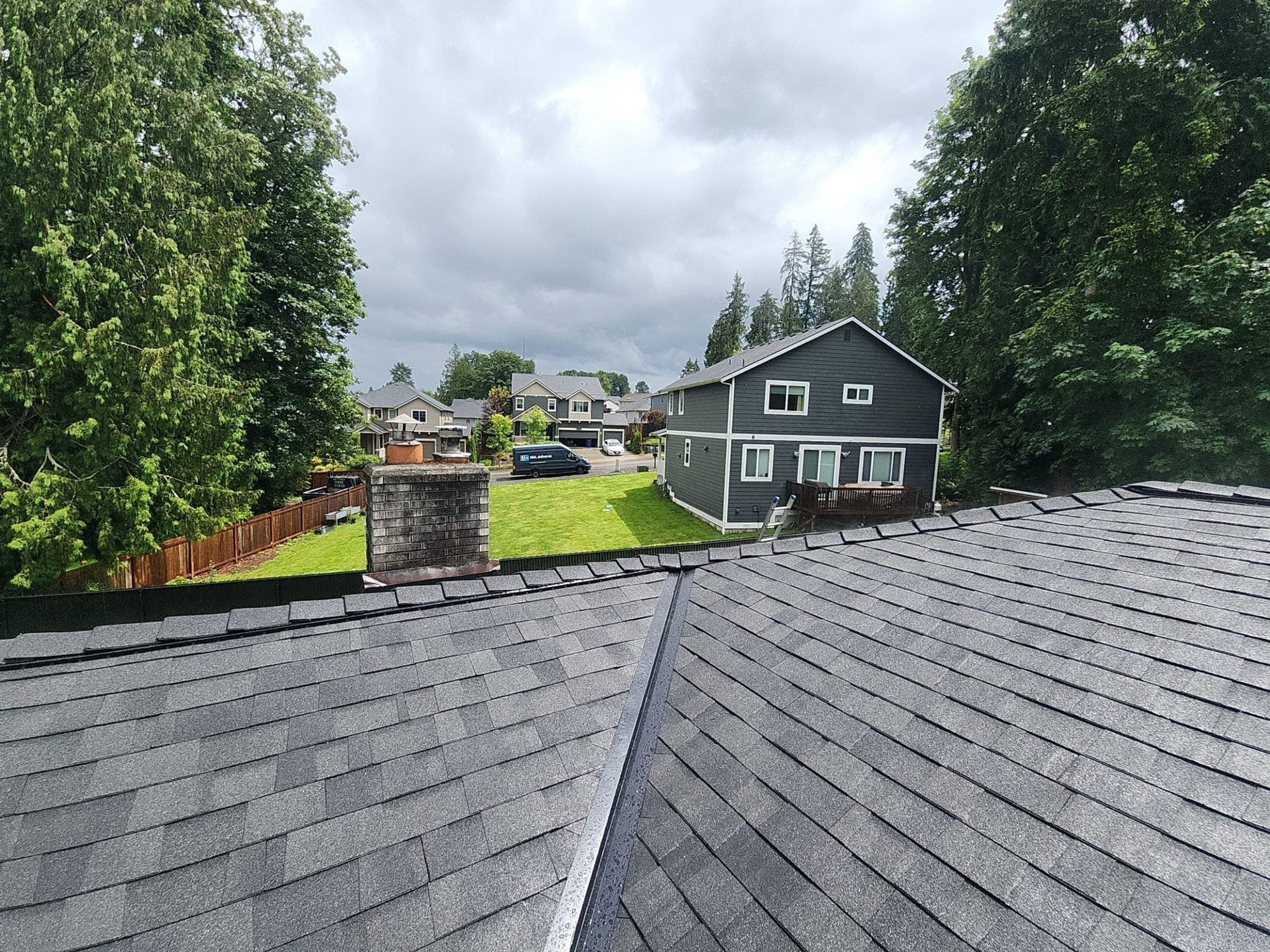 Ridge of the finished Malarkey Legacy Midnight Black roof looking toward the neighborhood, Lake Stevens, WA, by Amor Roofing