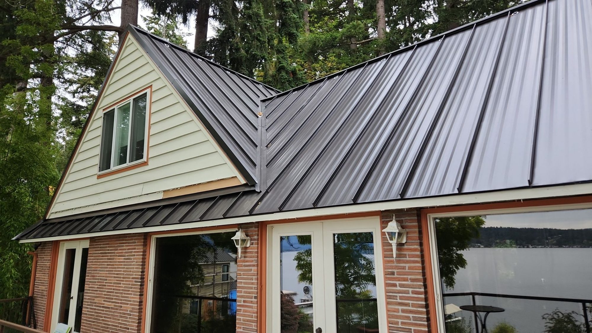 Finished Dark Bronze standing seam metal roof over the gable and the deck, Bellevue, WA