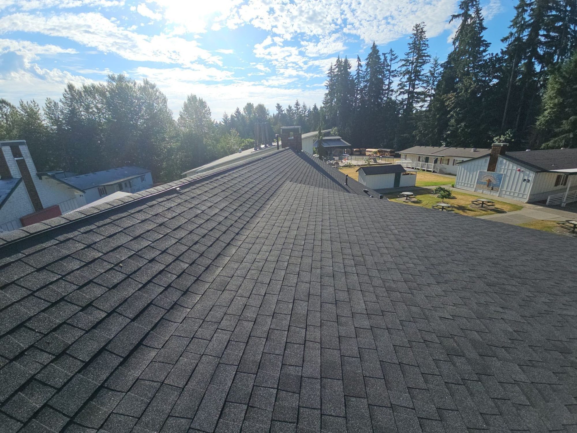 Finished Antique Black asphalt shingle roof ridge looking out over the campus, Woodinville, WA