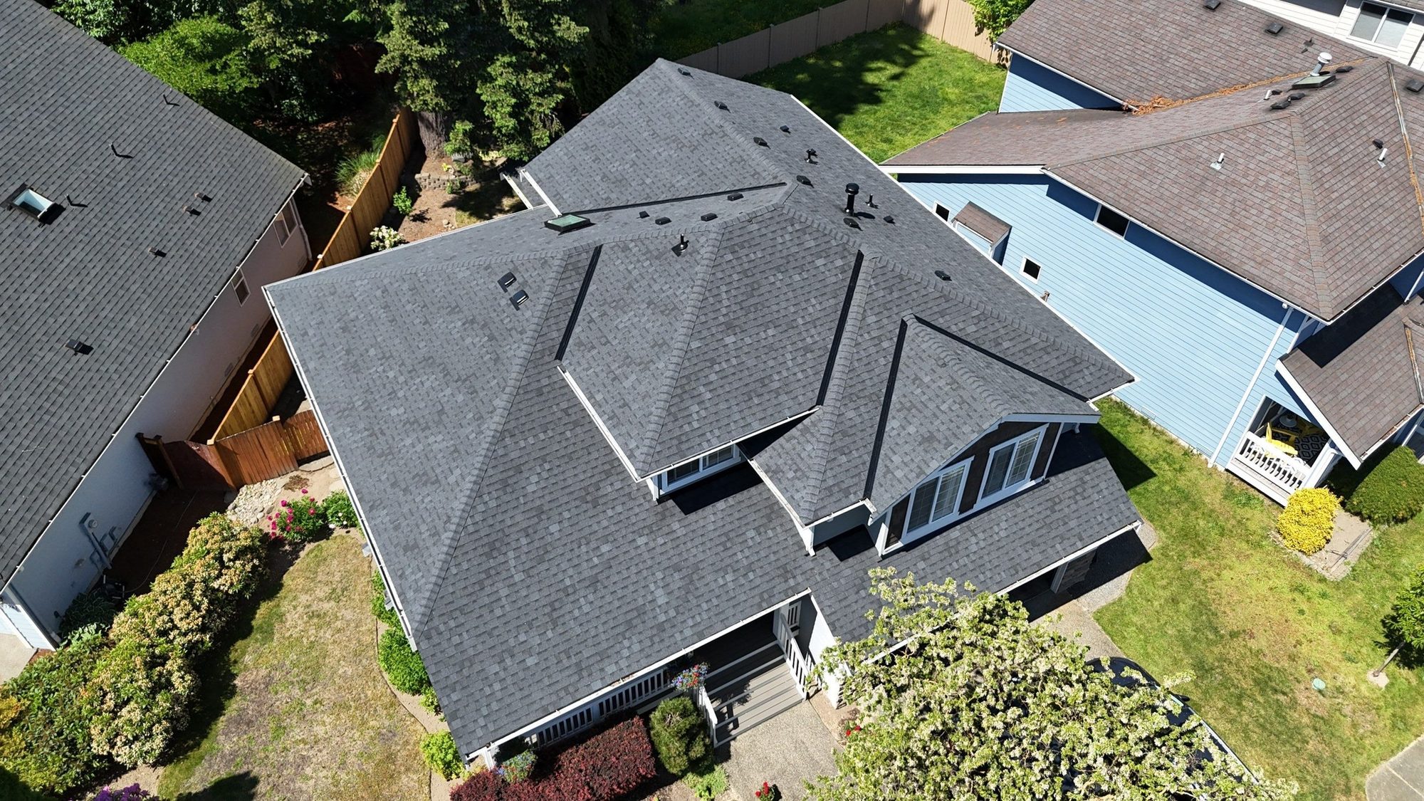 Aerial over the Pabco Premier Antique Black asphalt shingle roof with the skylights and box vents, Bothell, WA