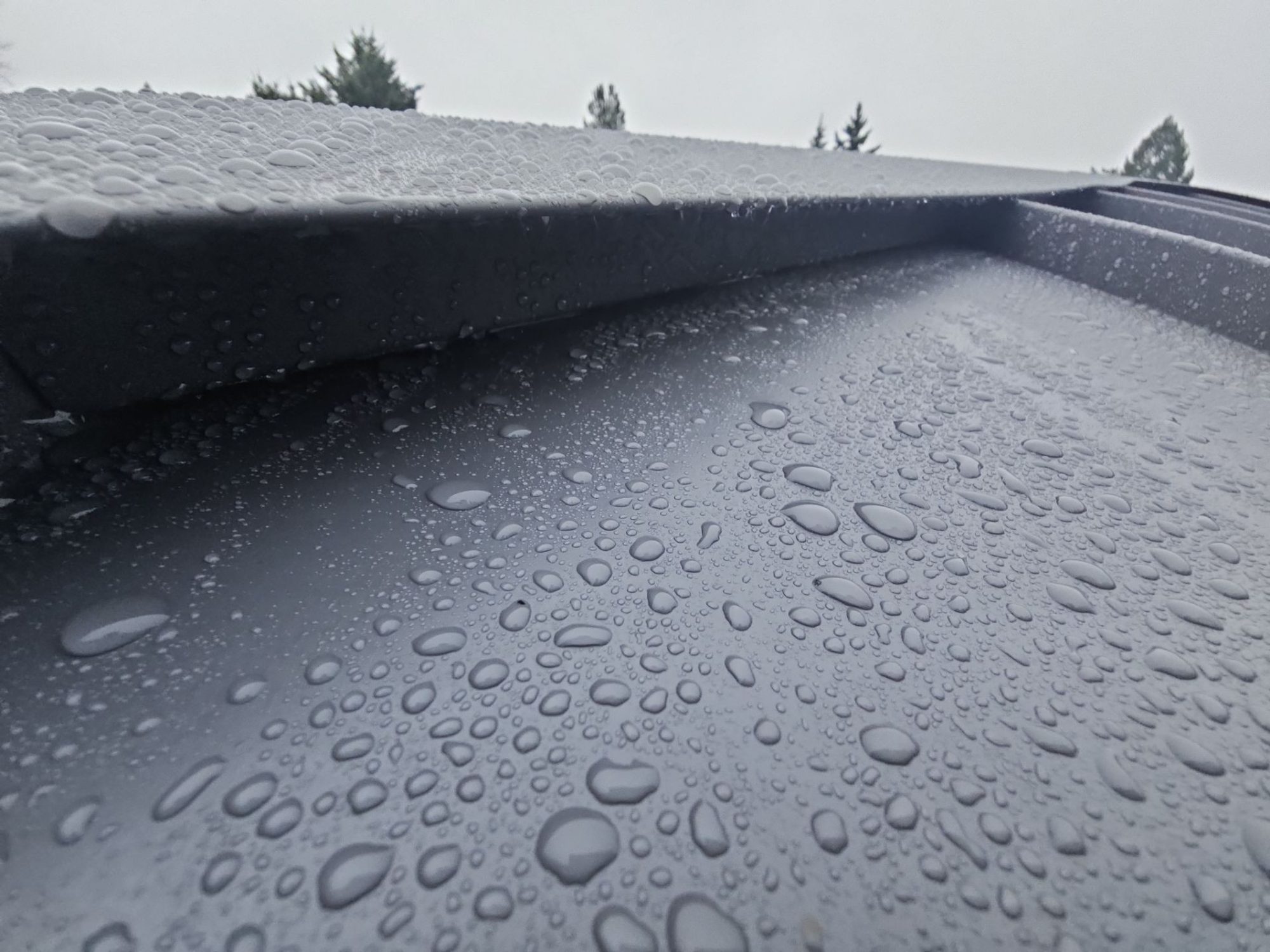 Close-up of rain on a Cascade Gray standing seam metal panel and seam, Woodinville, WA