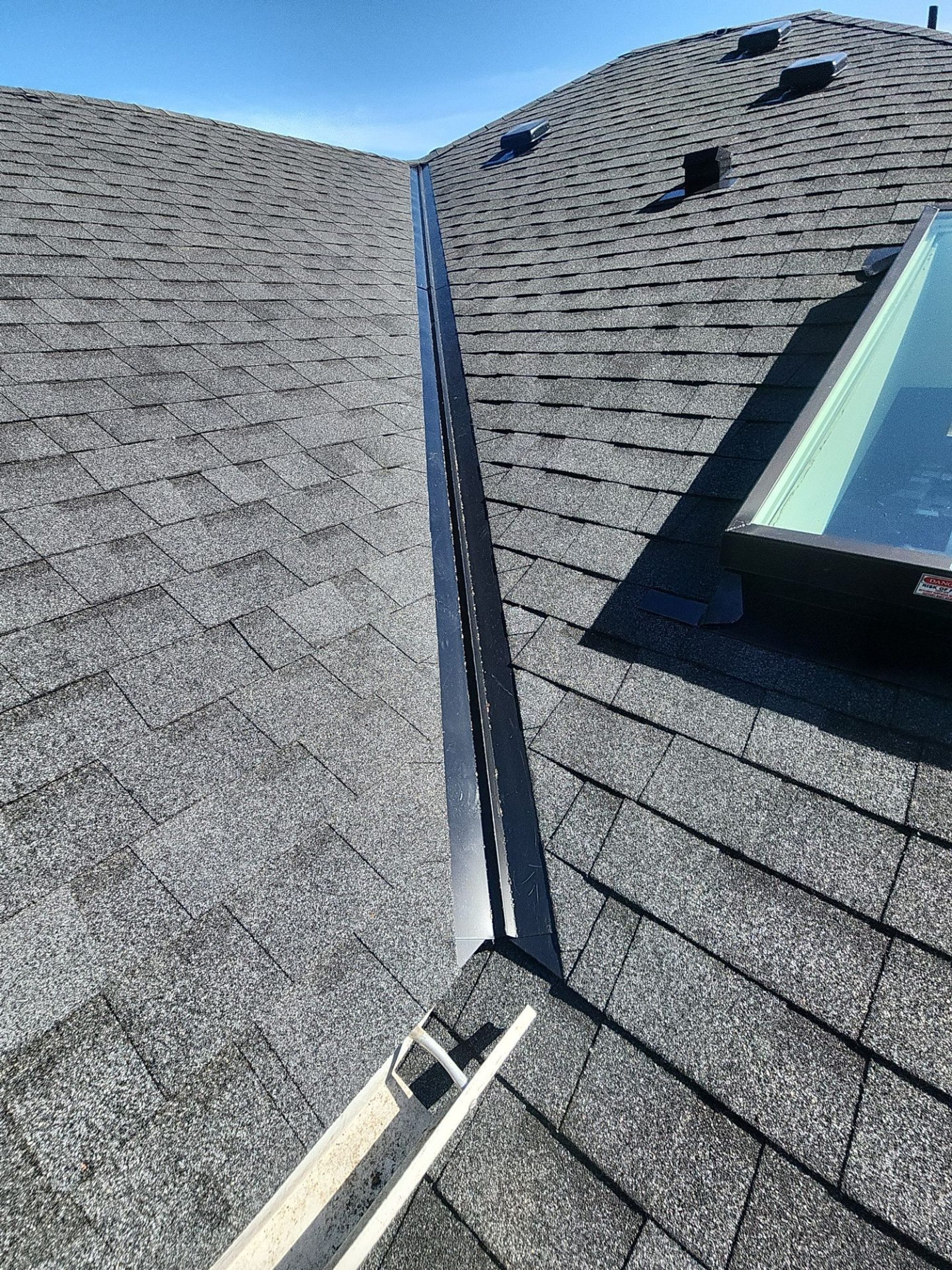 New skylight along the ridge of the Pabco Premier Antique Black asphalt shingle roof, Bothell, WA