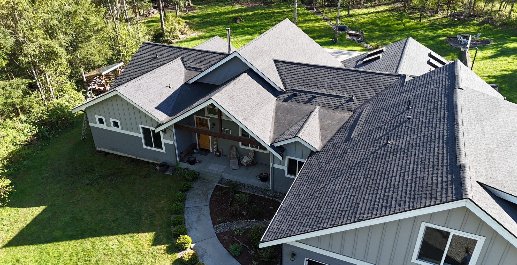 Aerial drone view of a completed Antique Black asphalt shingle roof on a Lake Stevens, WA home by Amor Roofing