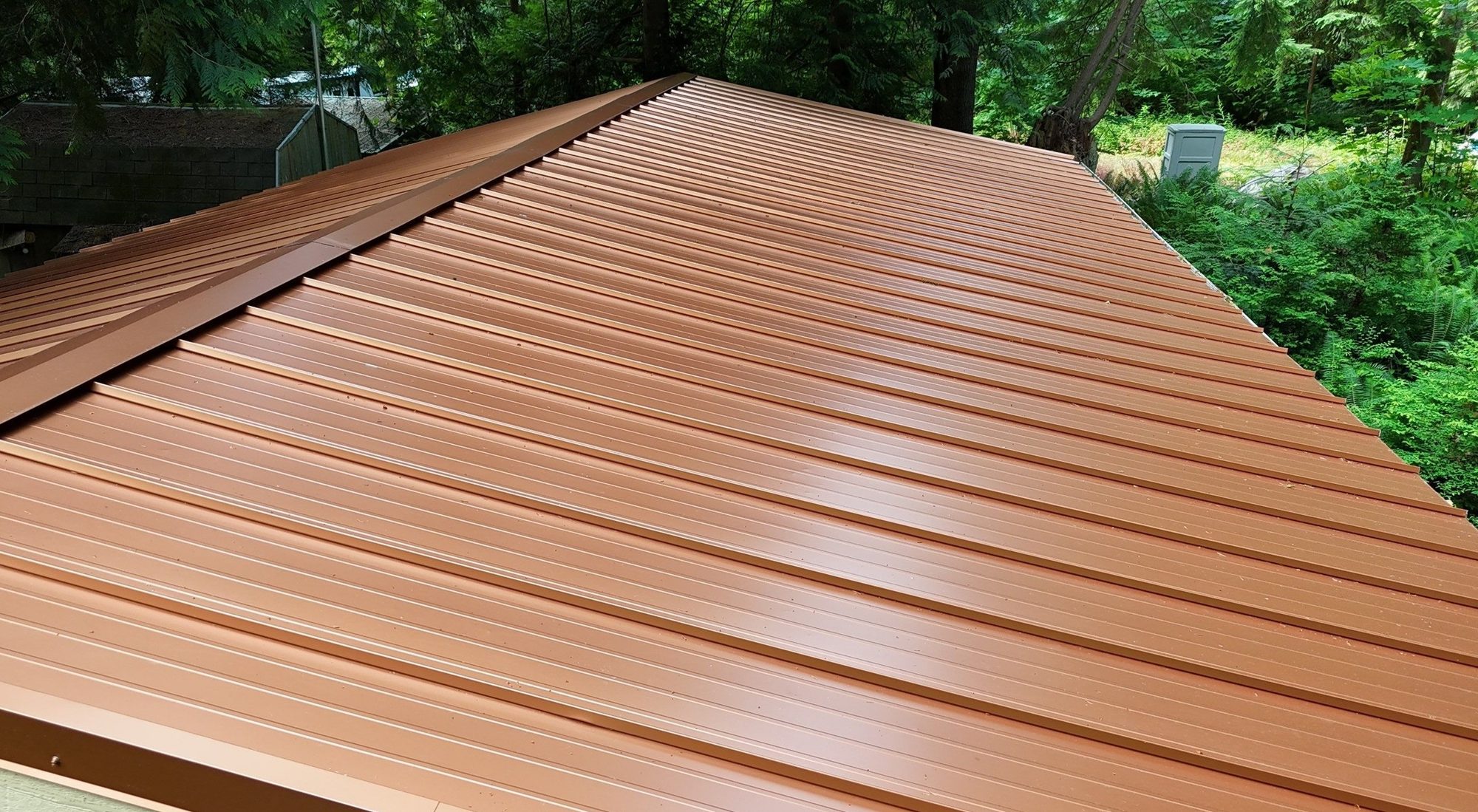 Finished Copper Penny standing seam metal roof running down to the eave, from above, Marysville, WA
