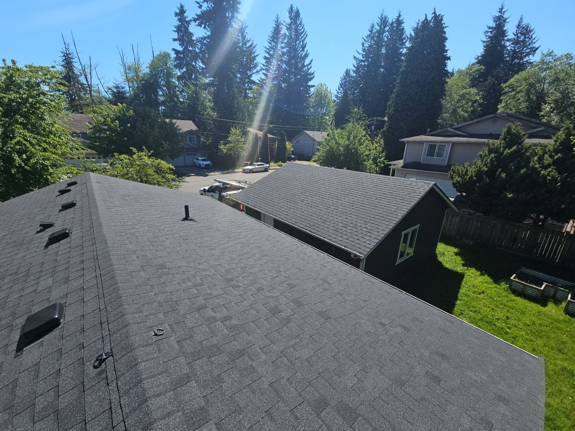 Aerial view of the finished Antique Black asphalt roof over a sunny neighborhood, Everett, WA