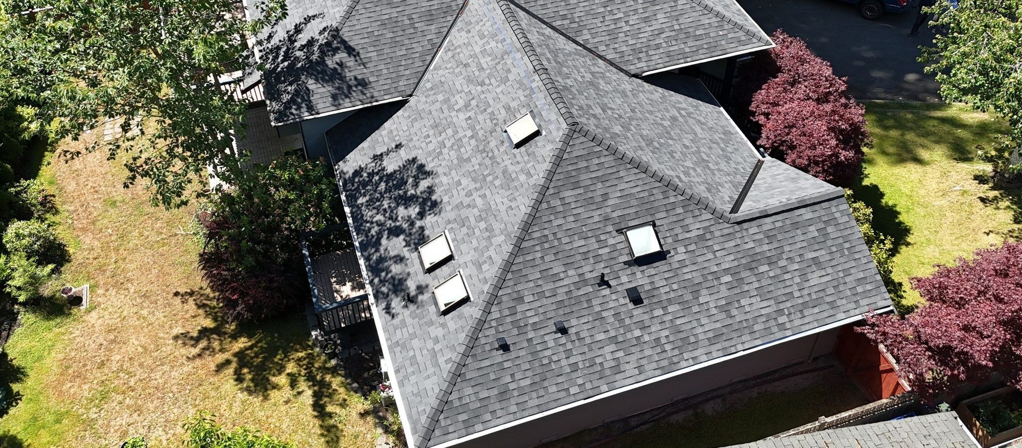 Three-quarter aerial of the finished Malarkey Vista Midnight Black asphalt shingle roof, Edmonds, WA