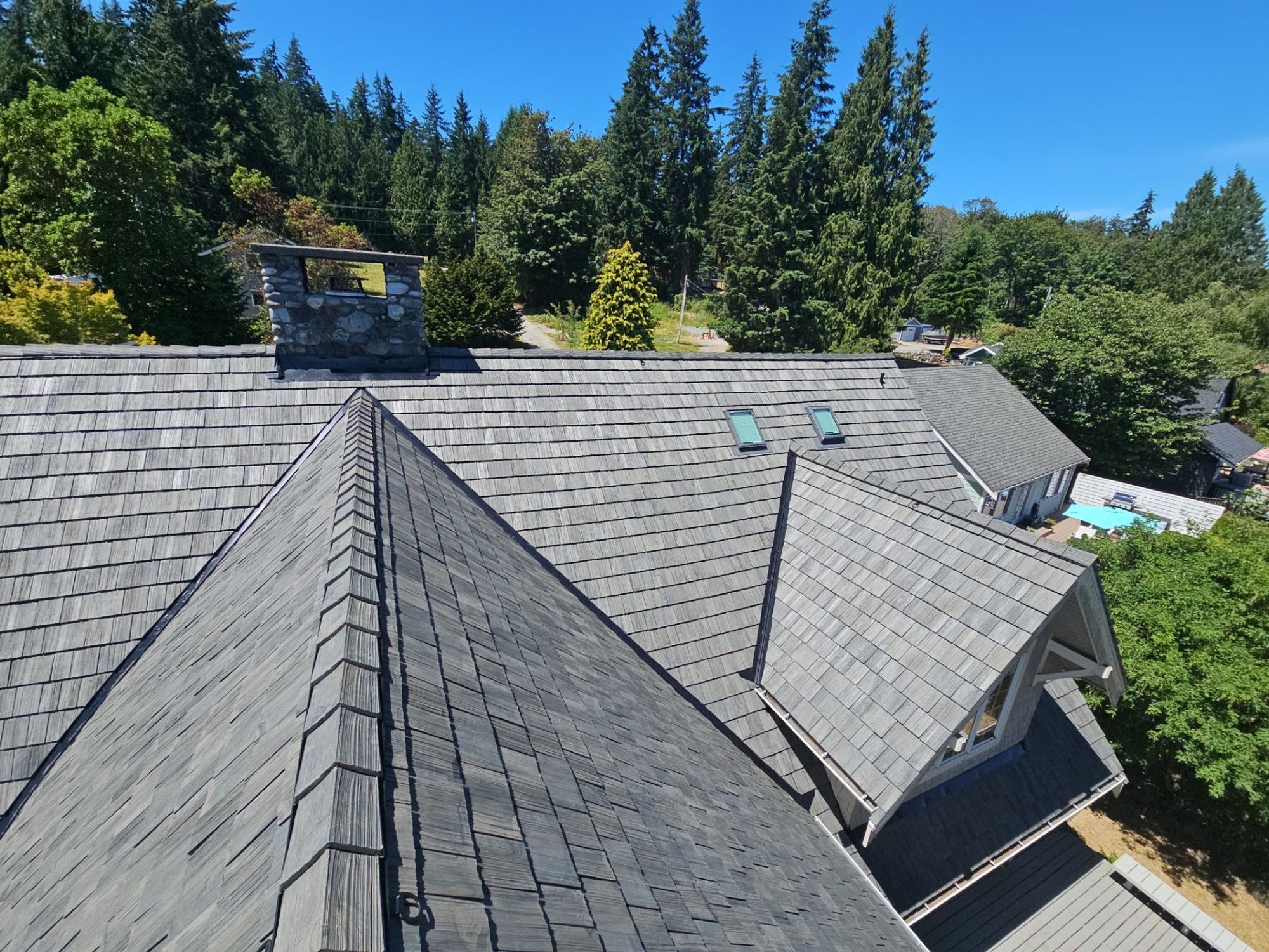 Amor Roofing Canyon Gray composite roof in Stanwood, after aerial planes chimney