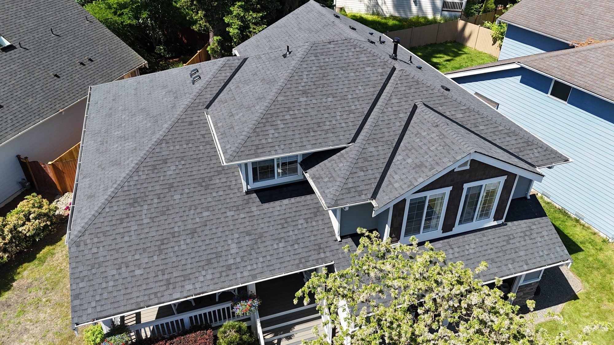 Drone view of the completed Pabco Premier Antique Black asphalt shingle roof with new skylights and box vents, Bothell, WA, by Amor Roofing