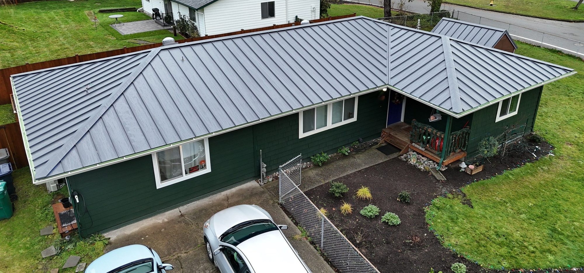 Drone view of a completed Cascade Gray standing seam metal roof on a Woodinville, WA home by Amor Roofing
