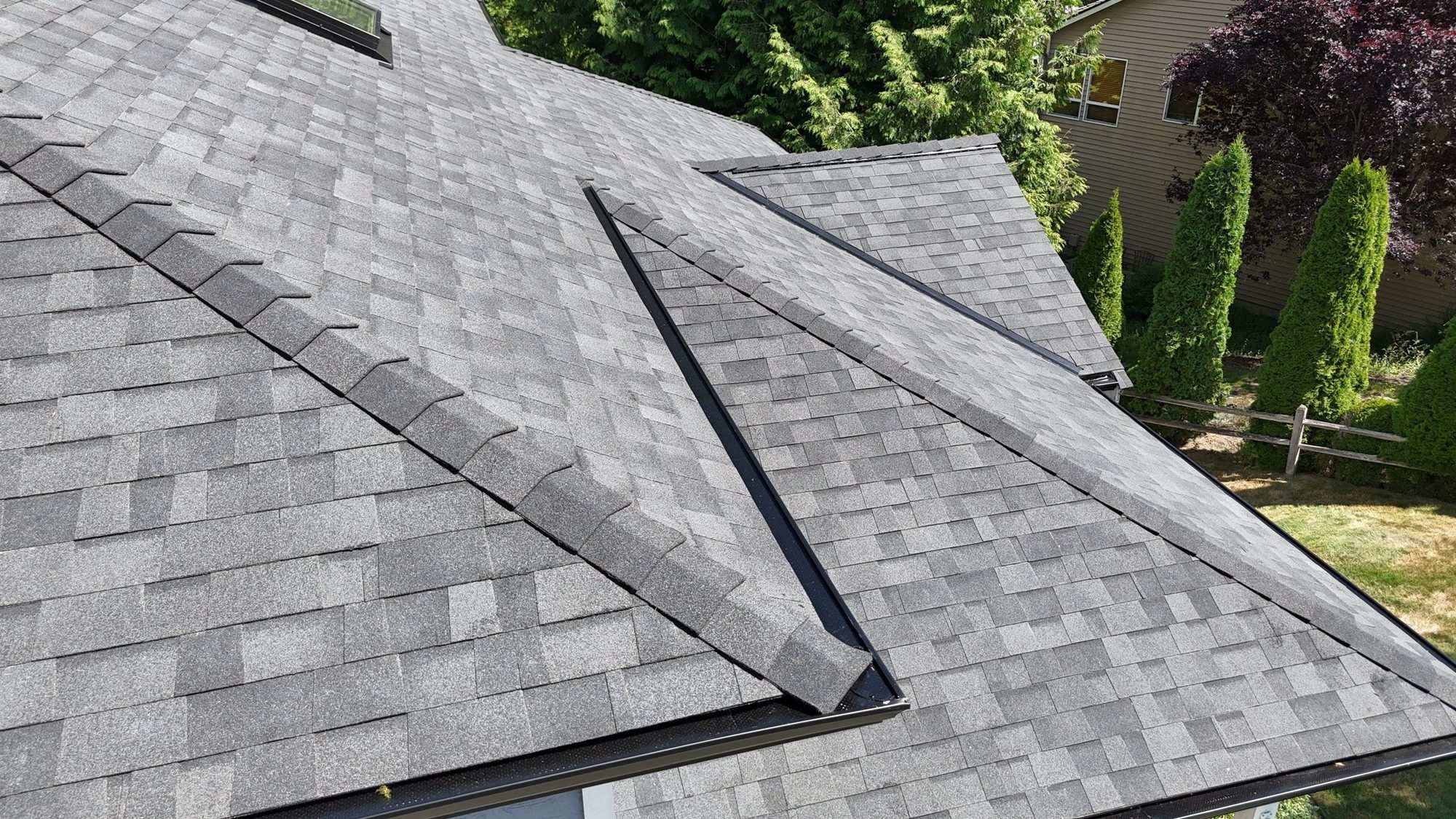 Drone view of the finished Malarkey Legacy Midnight Black asphalt shingle roof with new skylights, Lake Stevens, WA, by Amor Roofing