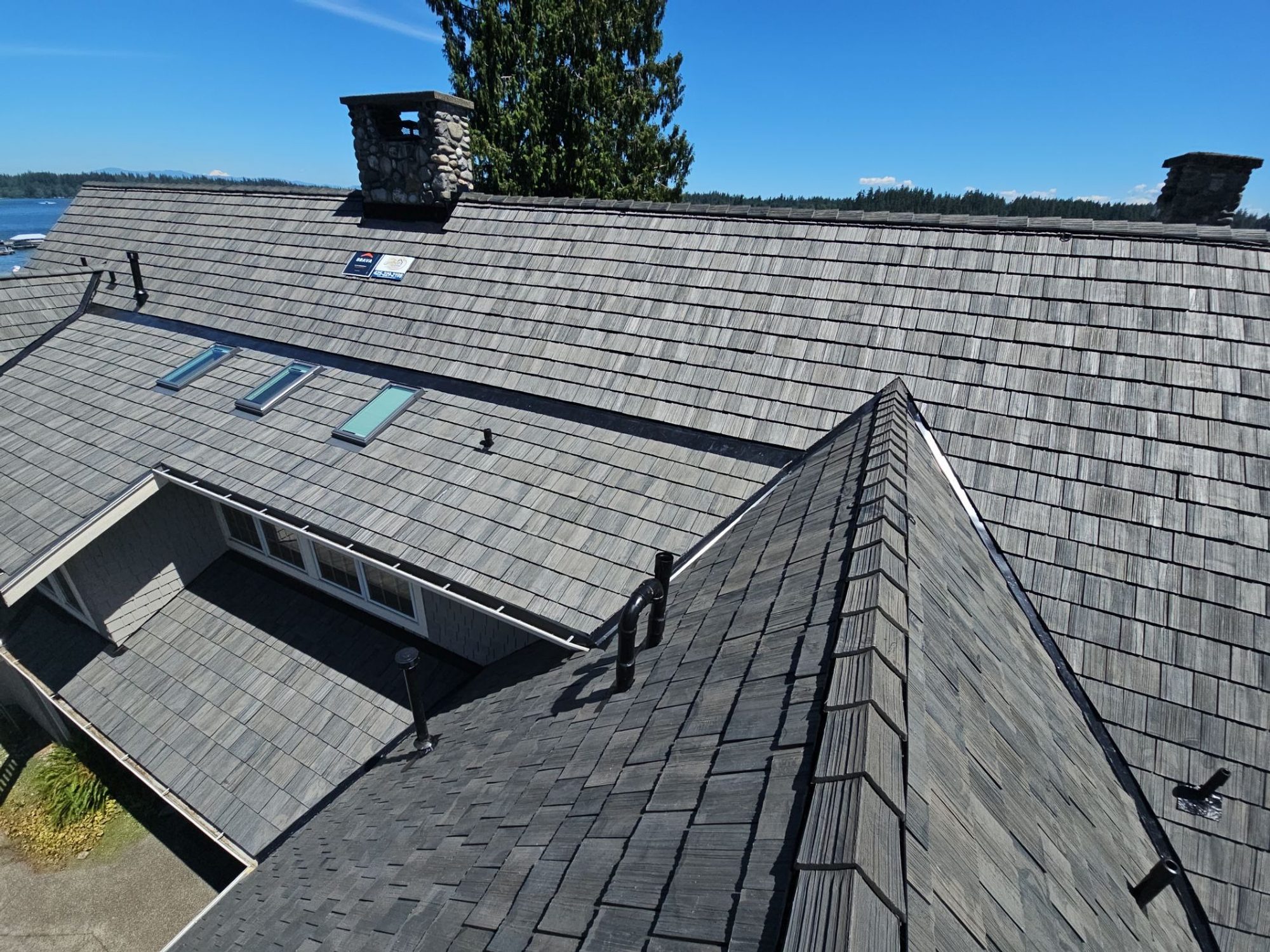 Amor Roofing Canyon Gray composite roof in Stanwood, after aerial skylights lake