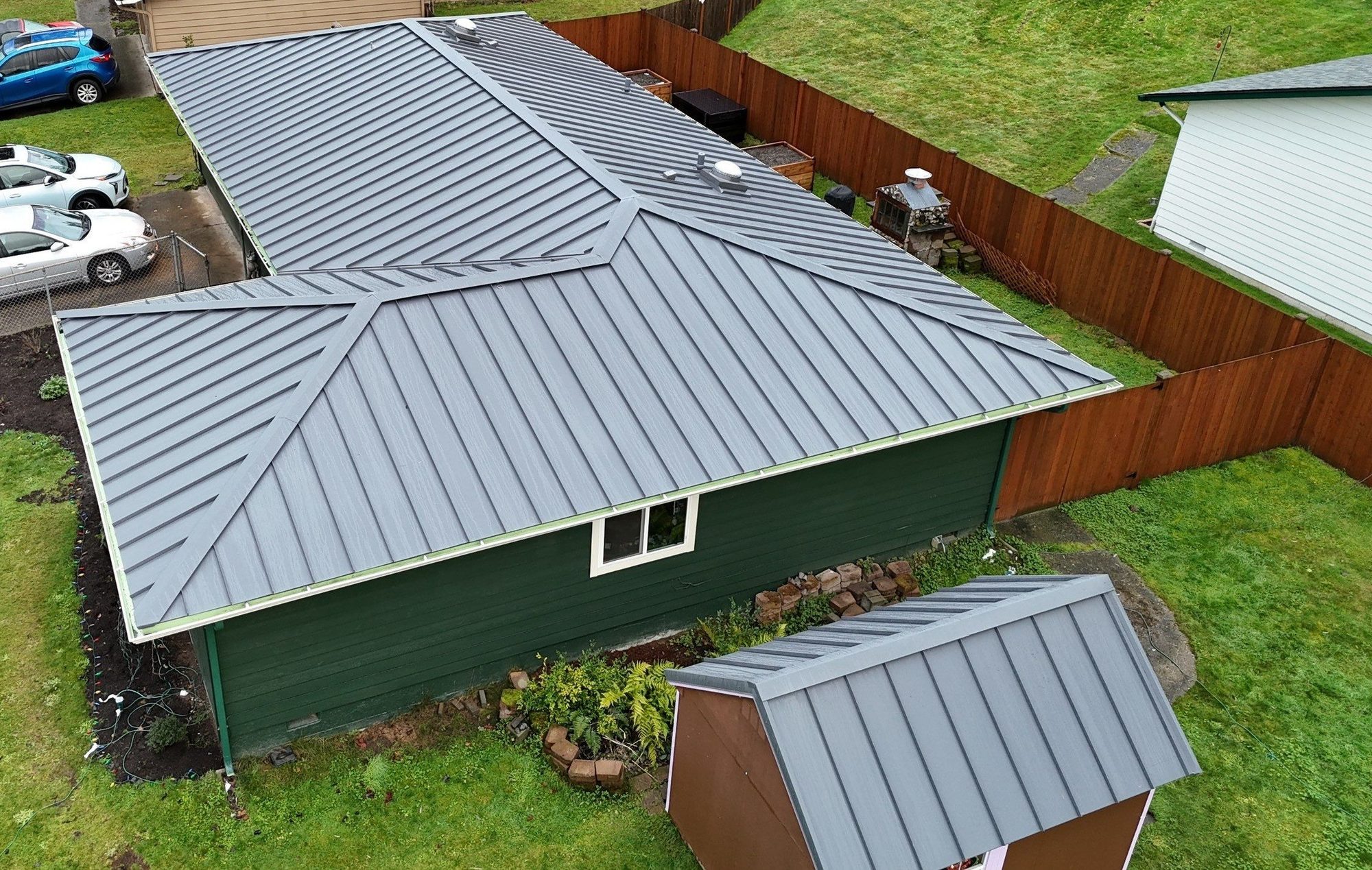 Aerial view of the Cascade Gray standing seam metal roof from the back yard with the matching re-roofed shed, Woodinville, WA