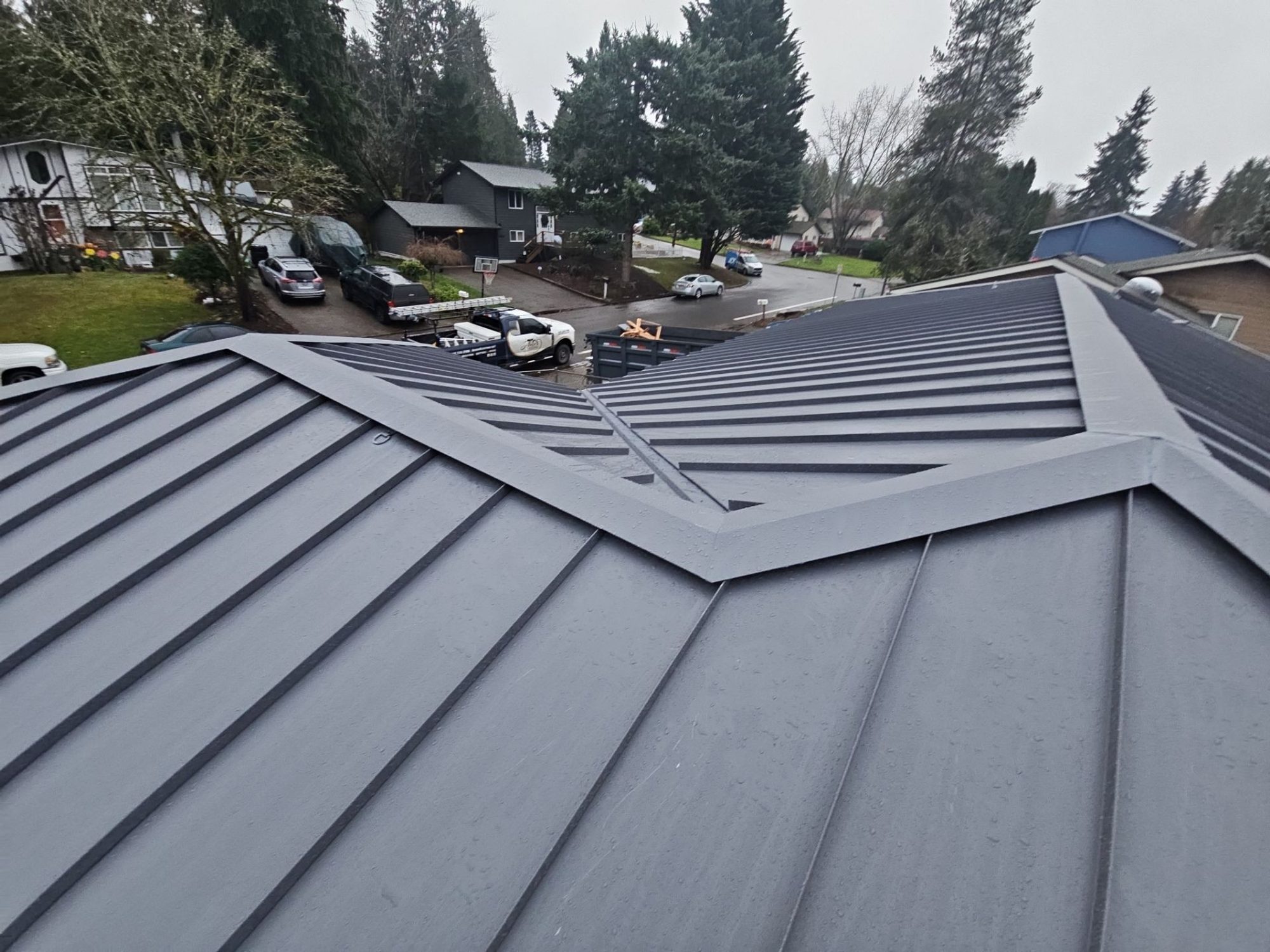 Hip joint detail where three planes of Cascade Gray standing seam metal meet, Woodinville, WA