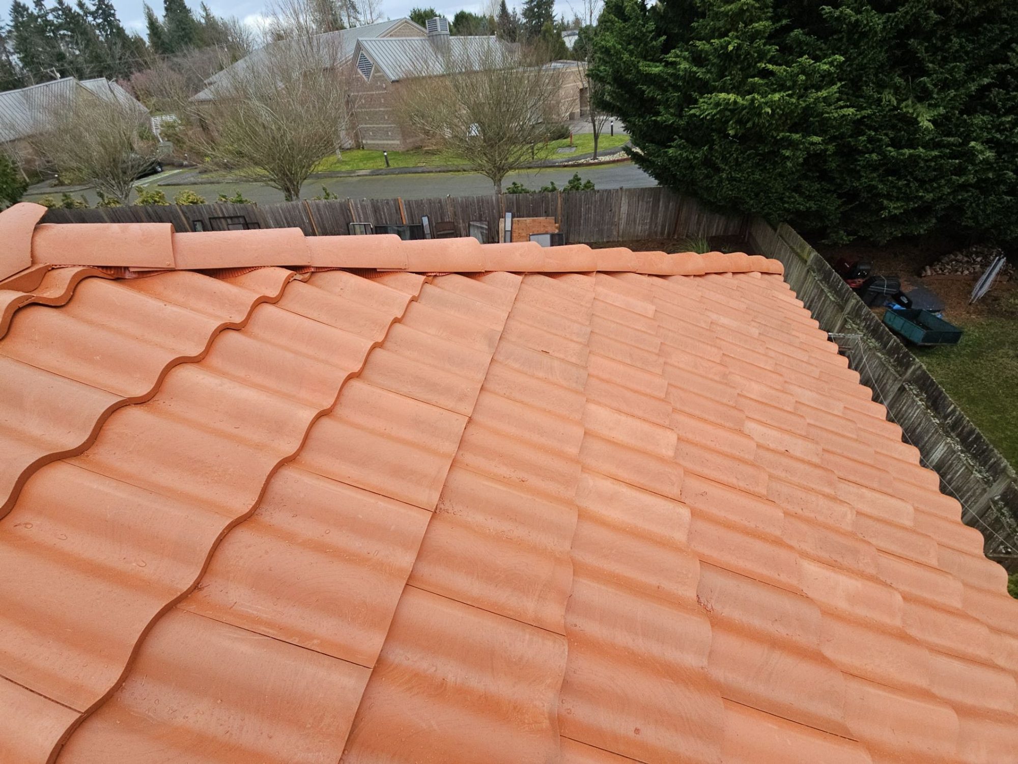 Field of Antique Clay Brava composite Spanish barrel tile with the ridge cap along the top, Mukilteo, WA